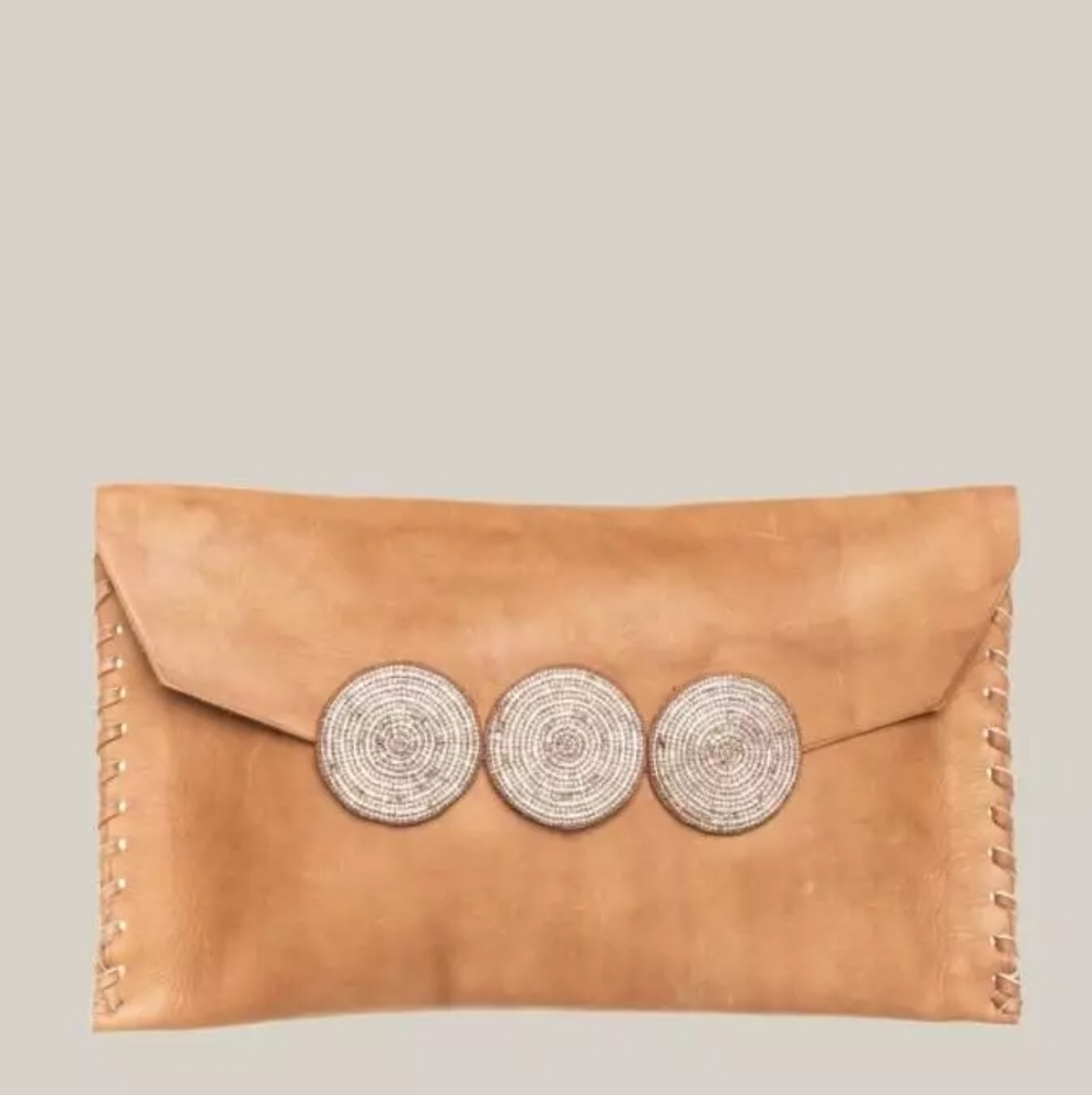 Leather clutch with woven strap.